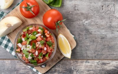 Traditional Mexican Pico de Gallo sauce in bowl on wooden table